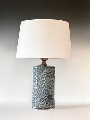 A repurposed muddled brown stone makes the neck of this lamp highlight the base & color