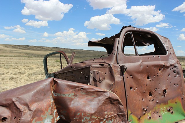 Abandoned truck shot full of holes, Red Desert Region, WY