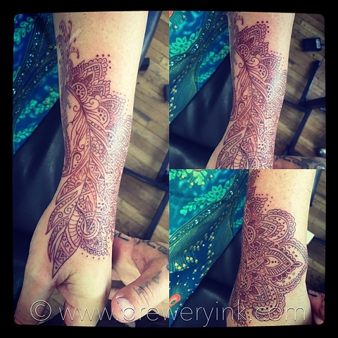 henna style feather hand tattoo
