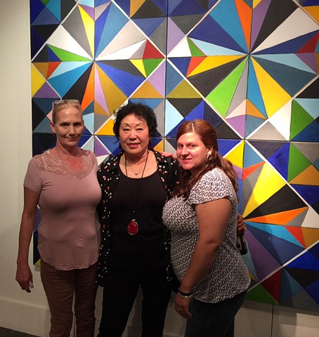 Artist Chun Hui Pak with gallery visitors interested in her Morning Glory artwork