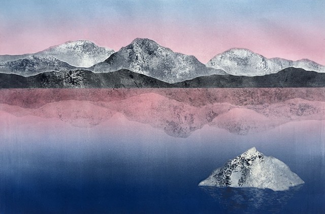 Mountains reflected in lake, pink sky