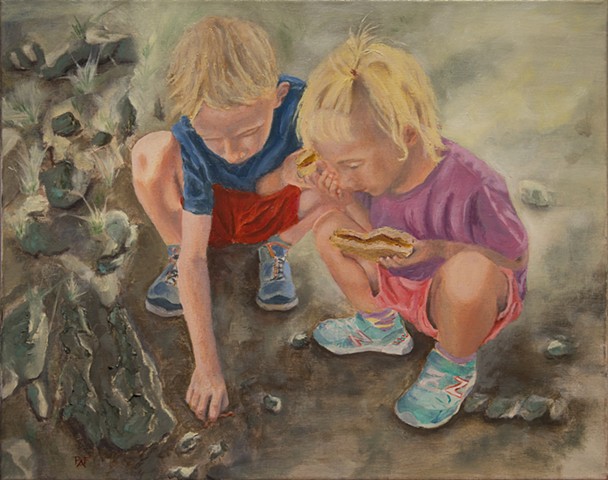 Two kids looking at a bug