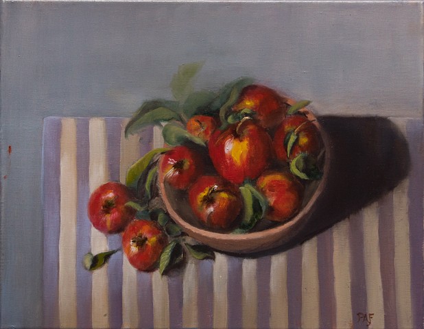 Heirloom apples in bowl on tablecloth
