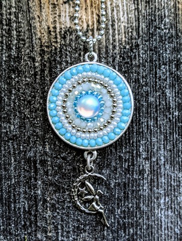 ICE BLUE ROUND PENDANT WITH MOON ANGEL CHARM