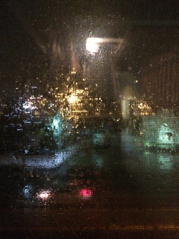 Through studio window, rainy night