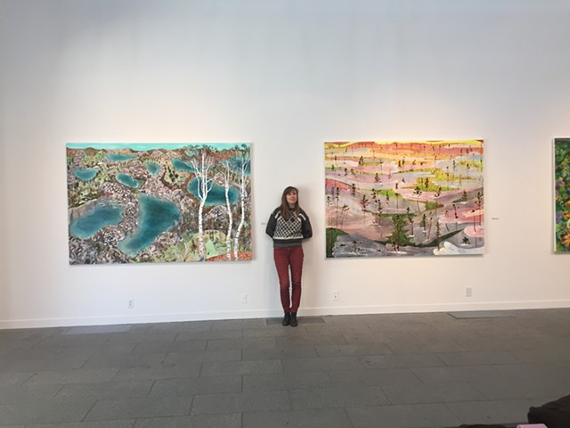 Rita between two paintings at Saint John's University. Collegeville, Minnesota. 2018