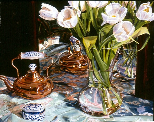 White tulips, green patterned cloth and brass teapot are reflected in a mirror.  White china with blue trim sits on the table.