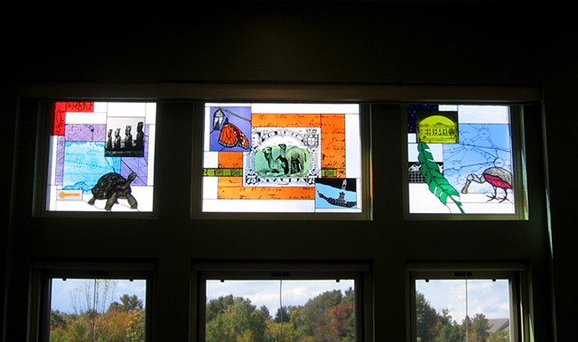Library windows with camel stamp, Galapagos Tortoise, Roseate Spoonbill, Monarch Butterfly, Easter Island figures, and more