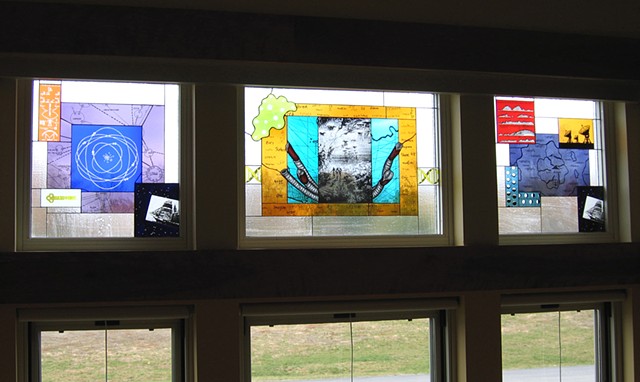 Cafeteria windows with imagery including an atom,  giant tube worms, map of Atlantis, a DNA double helix, illustration from Jules Verne's "A Walk Under the Waters", satellite dishes that are part of Allen Array