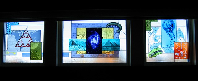 Cafeteria windows including images of our galaxy, Sierpinsky triangle, illustration from Jules Verne book, Burgess shale creatures, Atlas holding up our planet, Arecibo message