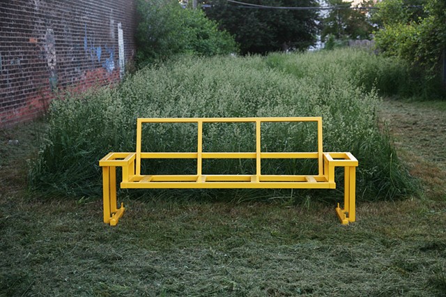 yellow glider frame in grass at studio