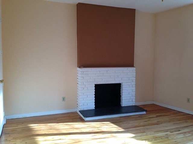 before the fireplace surround