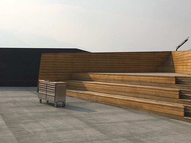 Lonely empty auditorium at Glacier Skywalk; grey sky; wooden seats