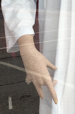 Mannequin hand broken missing fingers in a storefront window