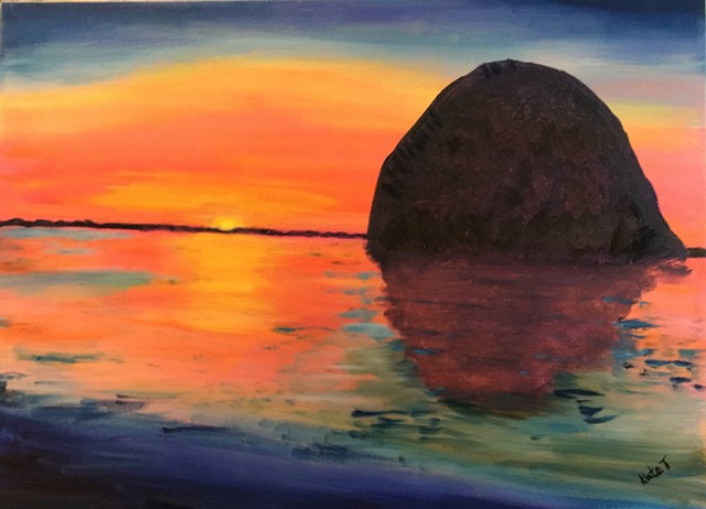 sunset at Morro Bay, CA with the distinctive hug boulder in the bay