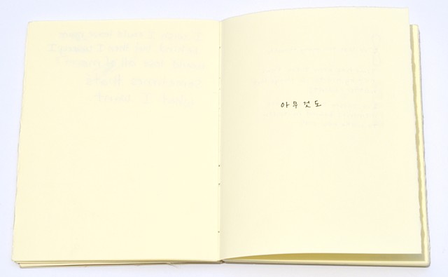 a small, white handmade book with writing in pen on the inside
