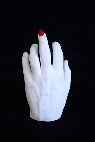 Plaster hand cast with red acrylic nail on the middle finger
