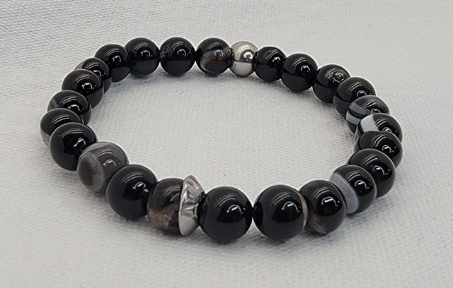 Bullseye Agate Bracelets, Handmade stretch bracelet with 8mm black Bullseye agate beads, with Stainless AMP Bead. Tibetan Bullseye Agate encourages strength, power, stability, and courage with grounding qualities. Made with care on double-strung 0.7mm str