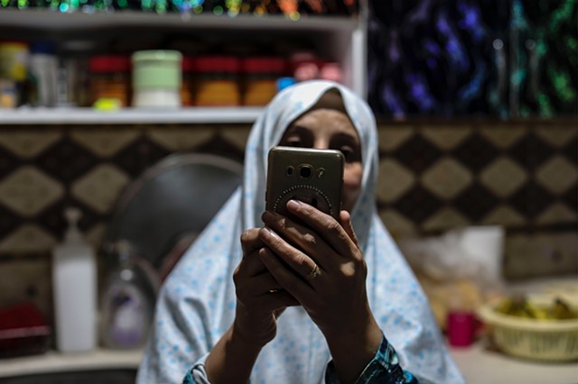 Baheya, Hala's mother, video chats with her eldest daughter, Hadice, who lives in Idlib, Syria. Baheya and Abu Mahmoud have been married for 18 years and live with four of their five children.
