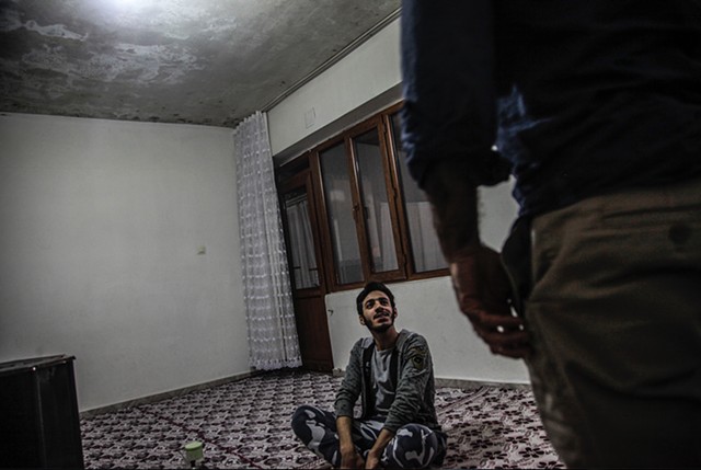 Mahmoud, 19, welcomes a visitor into the family home.