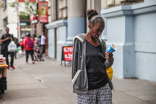 A homeless woman begs on 125th Street and Lexington Avenue on September 28, 2015. Issues with homelessness in Harlem have increased with the introduction and gaining popularity of K2, a drug marketed as synthetic marijuana.