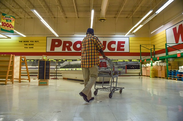 A shopper is seen walking near empty produce shelves at the Food Depot in Jackson, Miss., Monday, May 8, 2023. Food Depot’s permanent closure, set for Friday, will create multiple food deserts across nearby Jackson communities.