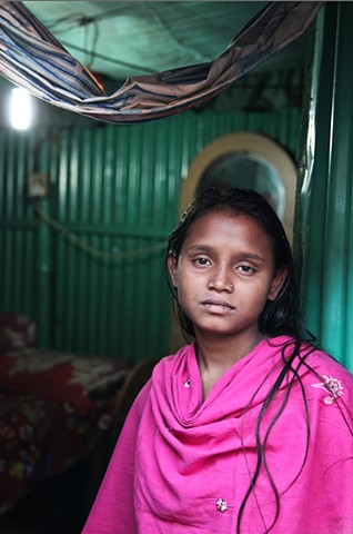A 14 year old sex worker at the C&B Ghat sex slum in Faridpur, Bangladesh. Young sex workers are given injected steroids like Oradexon, a drug usually given to cattle, to make them look older and more curvaceous. Long term use is said to be fatal.