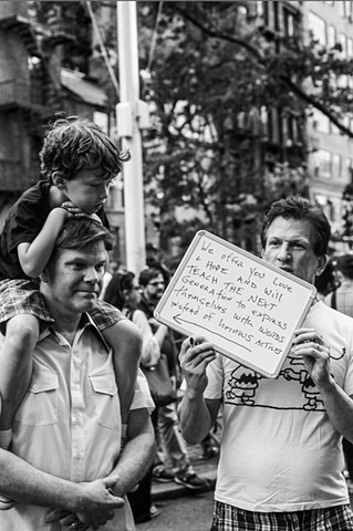 A couple protests with their son at a rally in support of the victims of the Orlando nightclub shootings at The Stonewall Inn in New York on June 12, 2016.