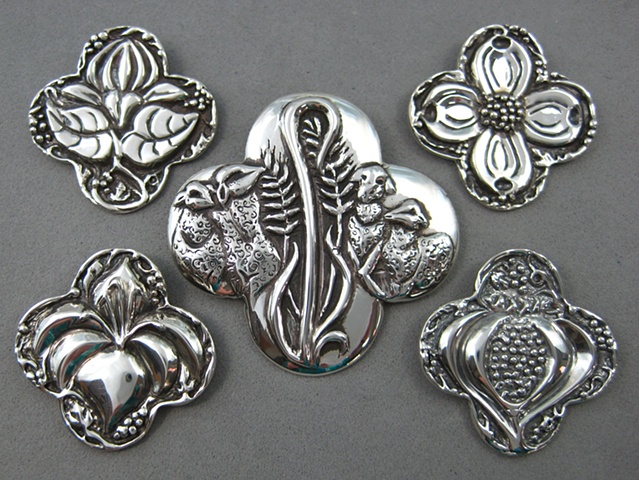 sterling silver quatrefoil shape pendants with symbolic elements ©Nancy Denmark