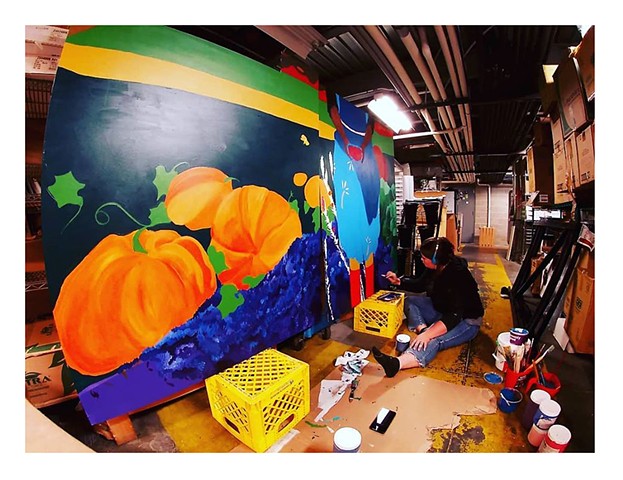 Artist Katlynne Hummell Underhill paints a large mural for New Pioneer Co-op in Coralville Iowa.