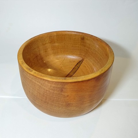 A small bowl, 4" in diameter, turned from figured maple