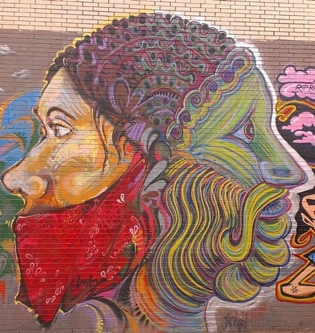 A Janus head Collaboration with street artist Wiley in midtown. Street art mural by Angel Quesada.