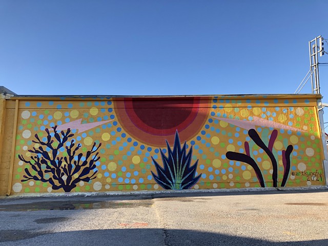 Mural by Angel Quesada in Pasadena, Texas. Colorful street art evoking growth.