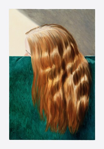 A woman's dyed red hair with visible roots draped over a green velvet couch