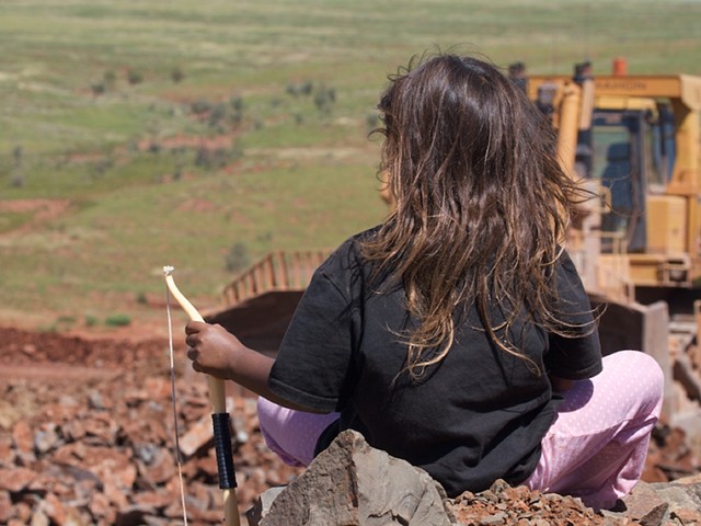 Image of girl looking on to Rio Tinto earthworks around bridge 13 after collapse. 