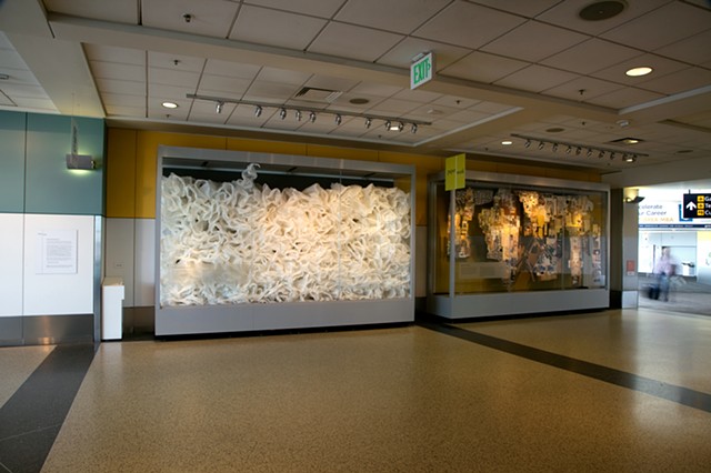 Installation of ESCAPE by Modesto Covarrubias next to quilt by Monica Canilao. Terminal 2, Oakland International Airport.