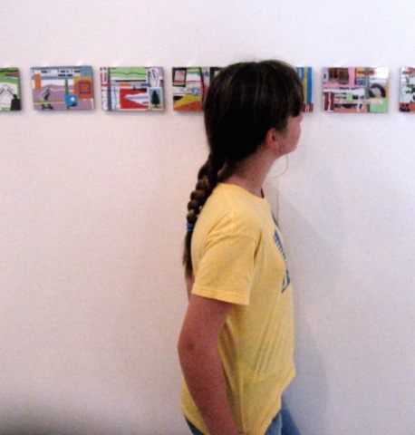 young patron looking at collages.