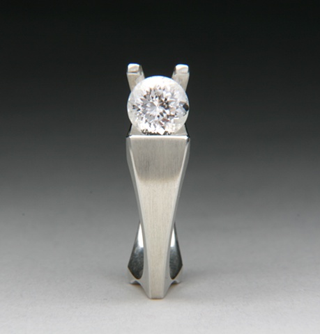 Snail ring is a contemporary design set with a white Danburite