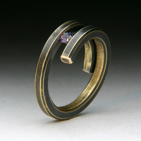 Bi-Pass Coil 14 karat yellow Gold Ring tension set with a color change Garnet