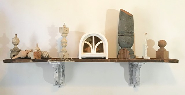 Arrangement of wooden remnants from various projects on found pine shelf, hung up with handmade corbel brackets.