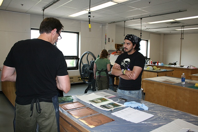 Mark Bovey speaking with a visual arts student