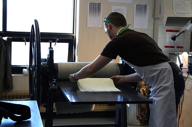 Mark Adams printing on the etching press