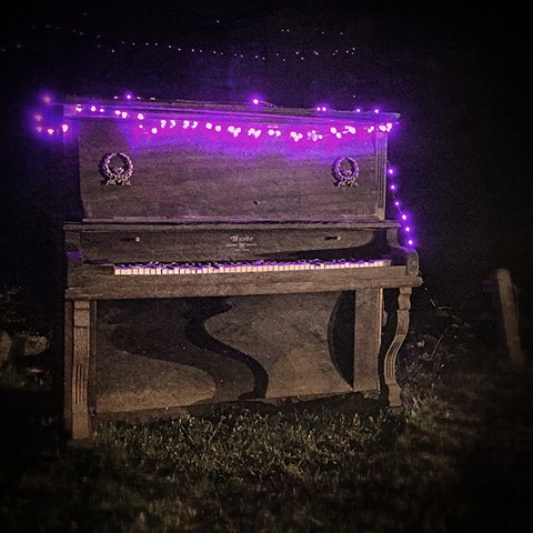 piano with purple lights at night