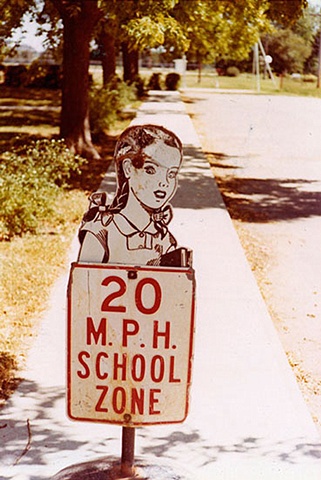 UNTITLED (CHILD AS SCHOOL SIGN)