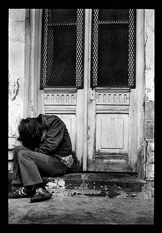 Young Man Hunched in Doorway