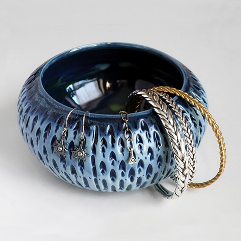 Blue porcelain shell thrown carved bowl with assorted silver & brass jewelry.