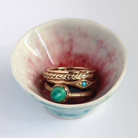 Tiny porcelain bowl with assorted gold rings