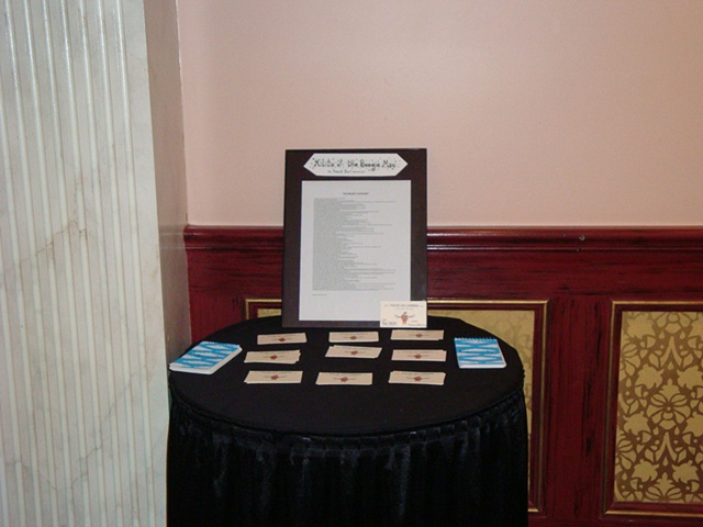 Table with Business Cards, Comment books and The Secret Covenant - Photo by Jessica Cormier
