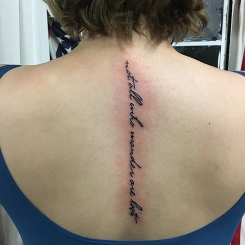 spine lettering tattoo