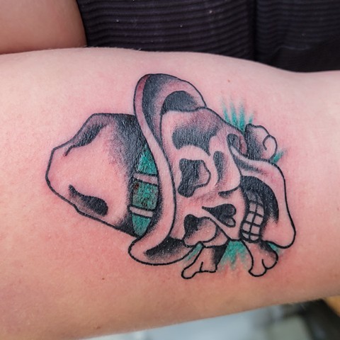 A tattoo of a bold and brightly coloured skull smiling, wearing a cowboy hat done by Jason Dopko at Good Times Tattoos in Saskatoon